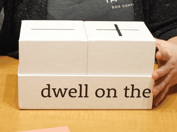 white custom made boxes for Dwelling Boxes Inc. feature die cuts and screenprint decoration